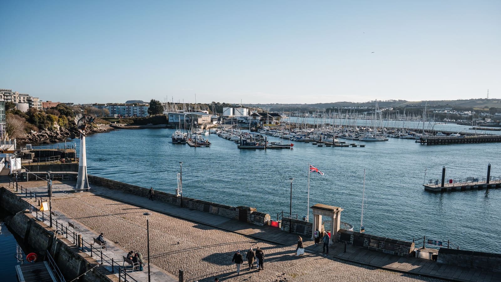 Cobbled quayside and harbour on the Plymouth waterfront, with boats moored in the marina